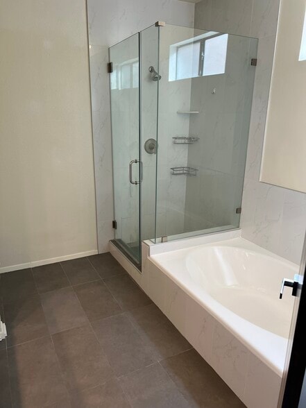 Remodeled bathroom with oval tub and shower stall - 4707 Willis Ave