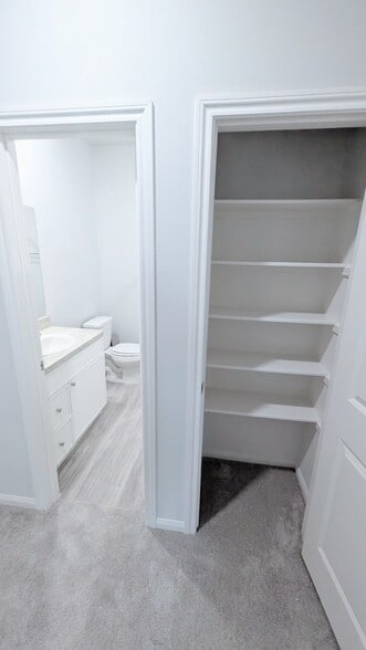 Conveniently located outside the bathroom, this storage closet can hold extra towels and linens. - 13218 HP Johnson St
