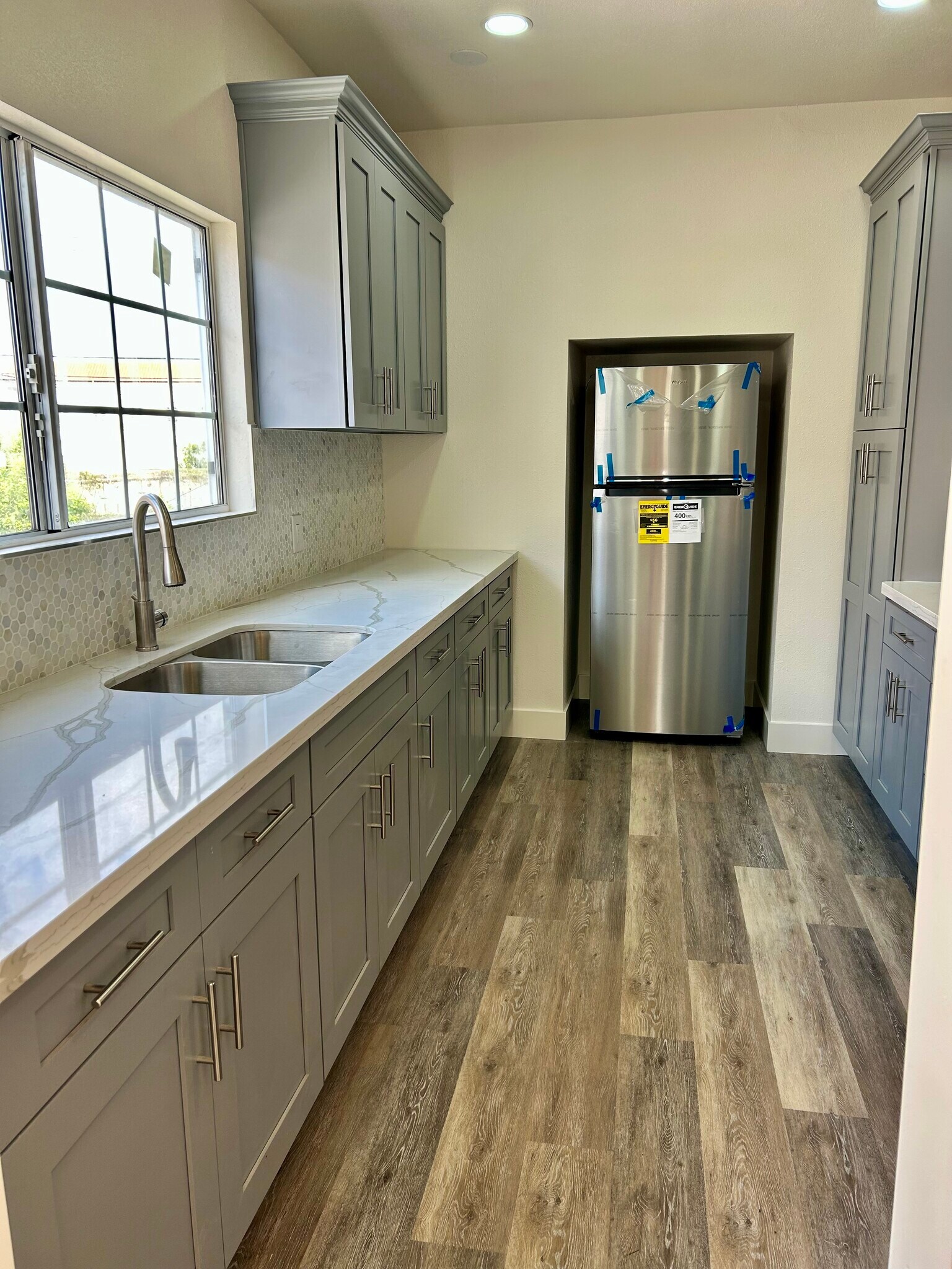 Fully remodeled kitchen with brand-new appliances and modern finishes. - 4043 1/2 W 21st St