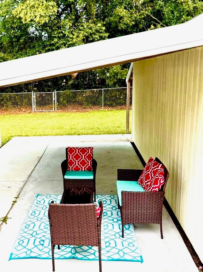 Outdoor seating overlooking fully fenced backyard - 345 E 13th St
