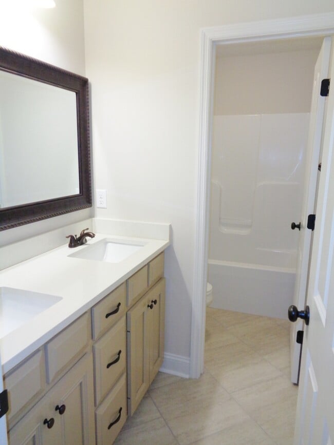 Building Photo - Spacious 4BR Home with Open Split Floor Plan, Granite Kitchen & Fenced Yard