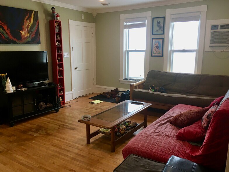 Looking back at the front door entrance in the living room. Windows face south. - 1320 Jefferson St NE