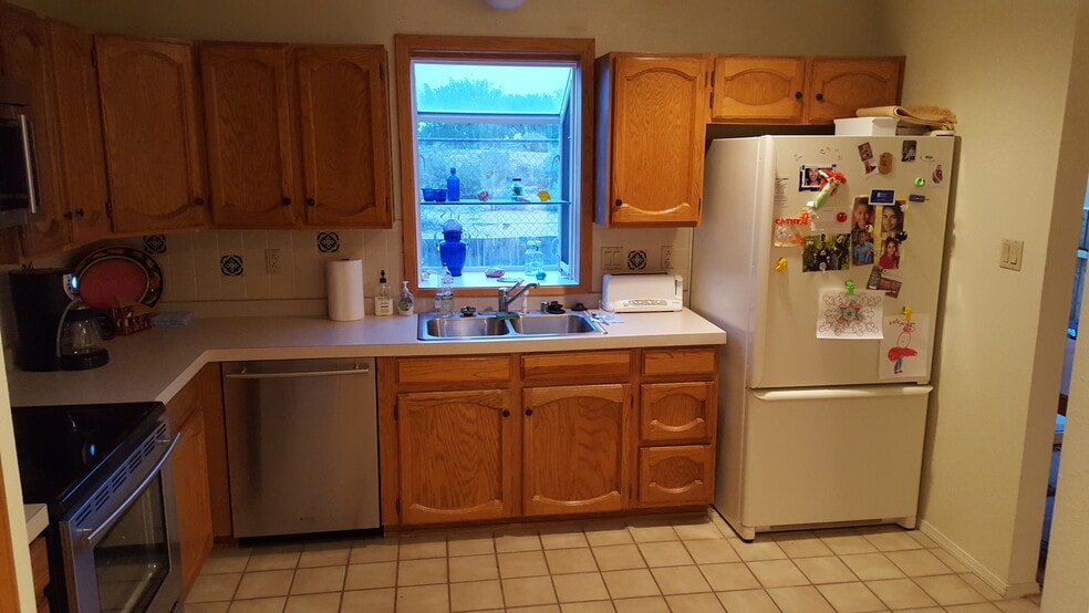 This is a view of the kitchen facing the golf course looking out of the bay window. - 6436 Saint Josephs Ave NW