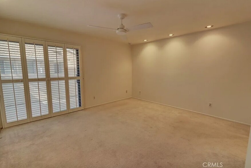 Primary bedroom slider opens onto back enclosed patio. Has fan & NEW recessed lights in most rooms. - 8566 Larkhall Cir