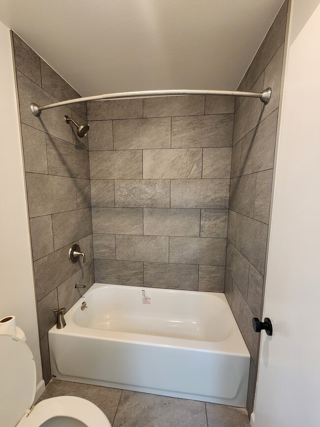 New bath tub, tile and rain shower shower head (finishing up the installation on the faucet!) - 8675 Falmouth Ave