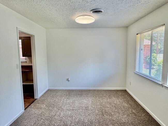 Building Photo - Cozy Meets Spacious: 4BR/2BA with Bonus Den & Patio