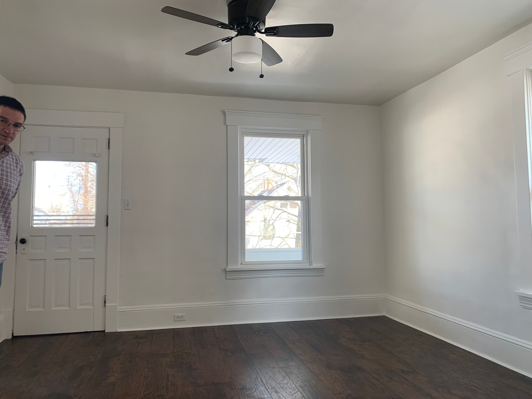 Living room with ceiling fan and door to the front balcony for warm summer days! - 4023 woburn ave