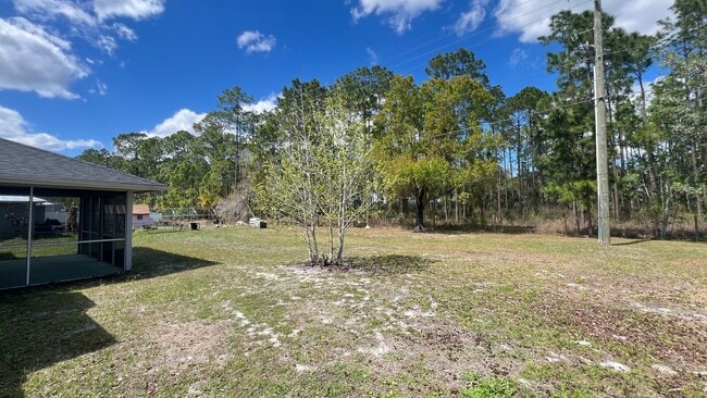 Building Photo - Bright & Spacious 3/2 Home with Huge Yard + Screened Patio — Lawn Care Included!