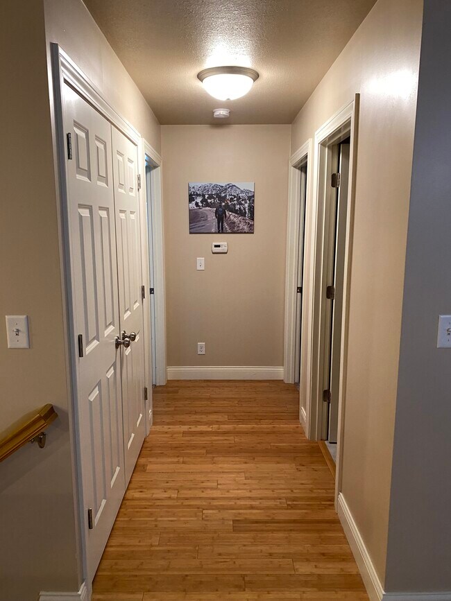 Hallway to main floor laundry, bathroom, and 2 bedrooms - 109 Scenic Dr