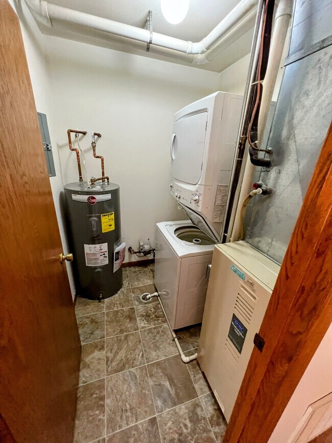 in-unit laundry featuring a washer, dryer, and furnace/AC conveniently tucked away in its own space - 213 Ash Street