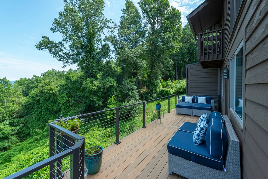Your private mountain retreat: Expansive deck with stunning forest views. - 405 Windswept Dr