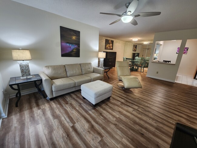 Bright, open-concept living area and dining area. - 1935 Silver Pine SW Way