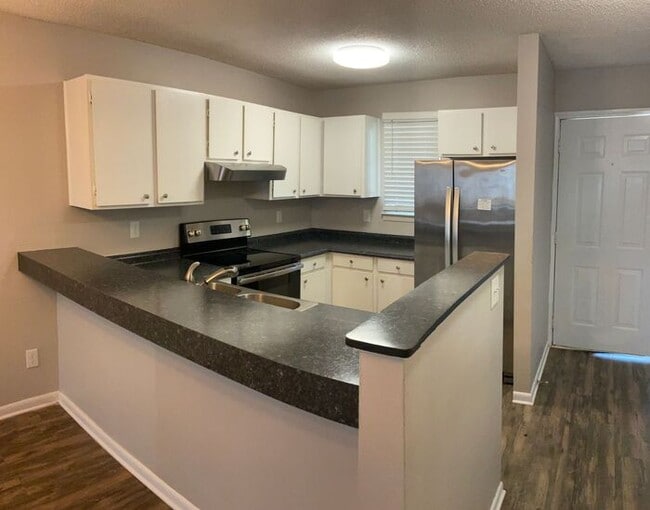 Building Photo - Just off the main road, but in walking dis...