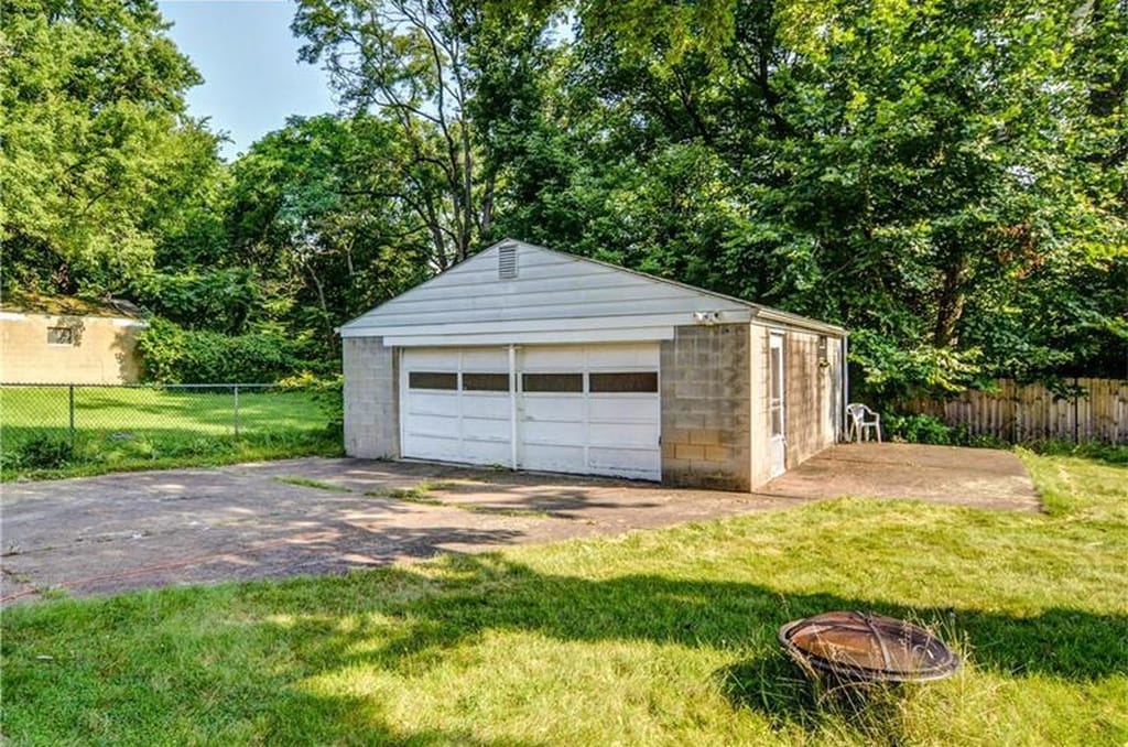 Two car detached garage with auto door and cement driveway leading out to the street - 2038 Stonelea St