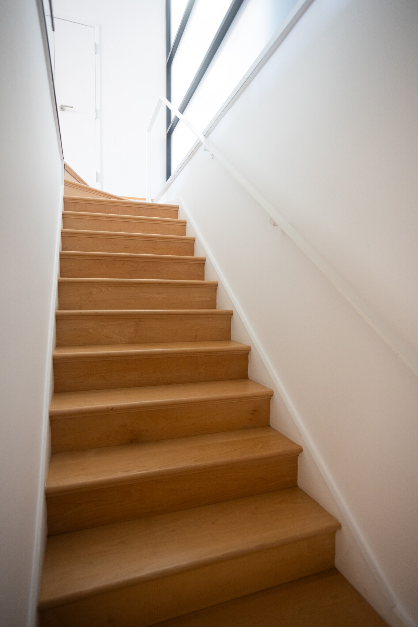 Staircase from kitchen and dining area leading downstairs to the primary bedroom and bathroom. - 2250 11th St NW