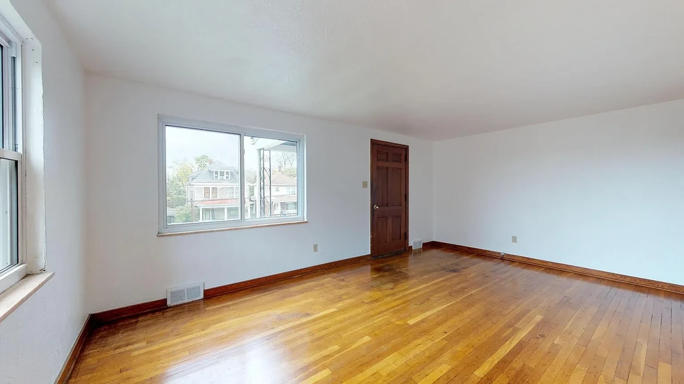 Spacious living room with refinished original hardwood flooring. - 31 Marylea Ave