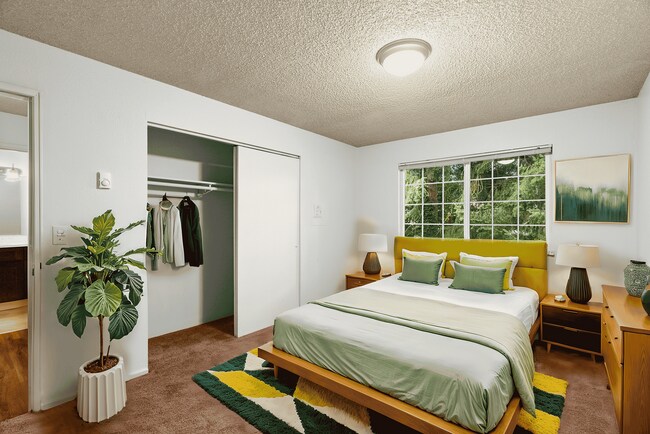 Experience tranquility in this beautifully decorated bedroom featuring nature-inspired accents. - University Crossing Apartments