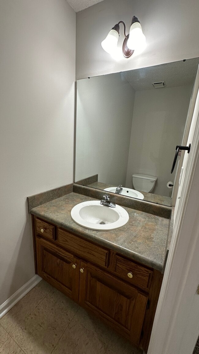 Half-bath is located downstairs off of the kitchen and living room. - 1211 Goldridge Dr SW