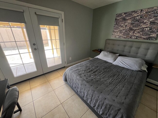 Master bedroom + french doors leading to backyard - 9440 N 52nd Ln