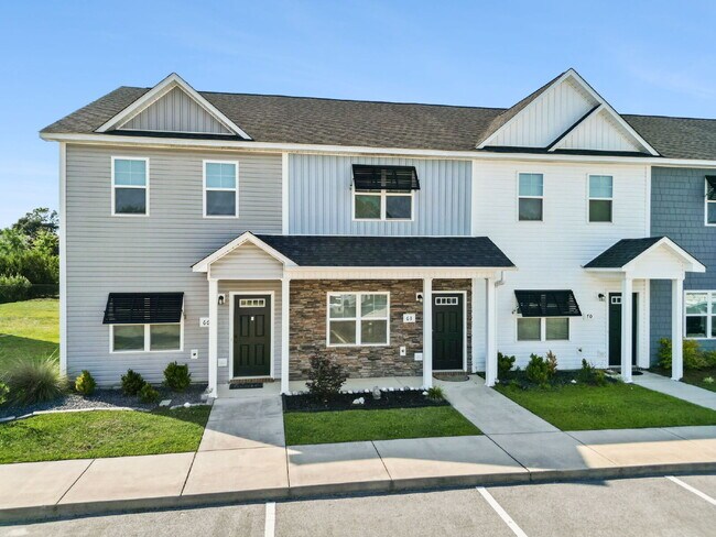 Building Photo - Available Now! Enjoy low-maintenance coastal living in this beautiful 2-bedroom, 2.5-bath townhom...