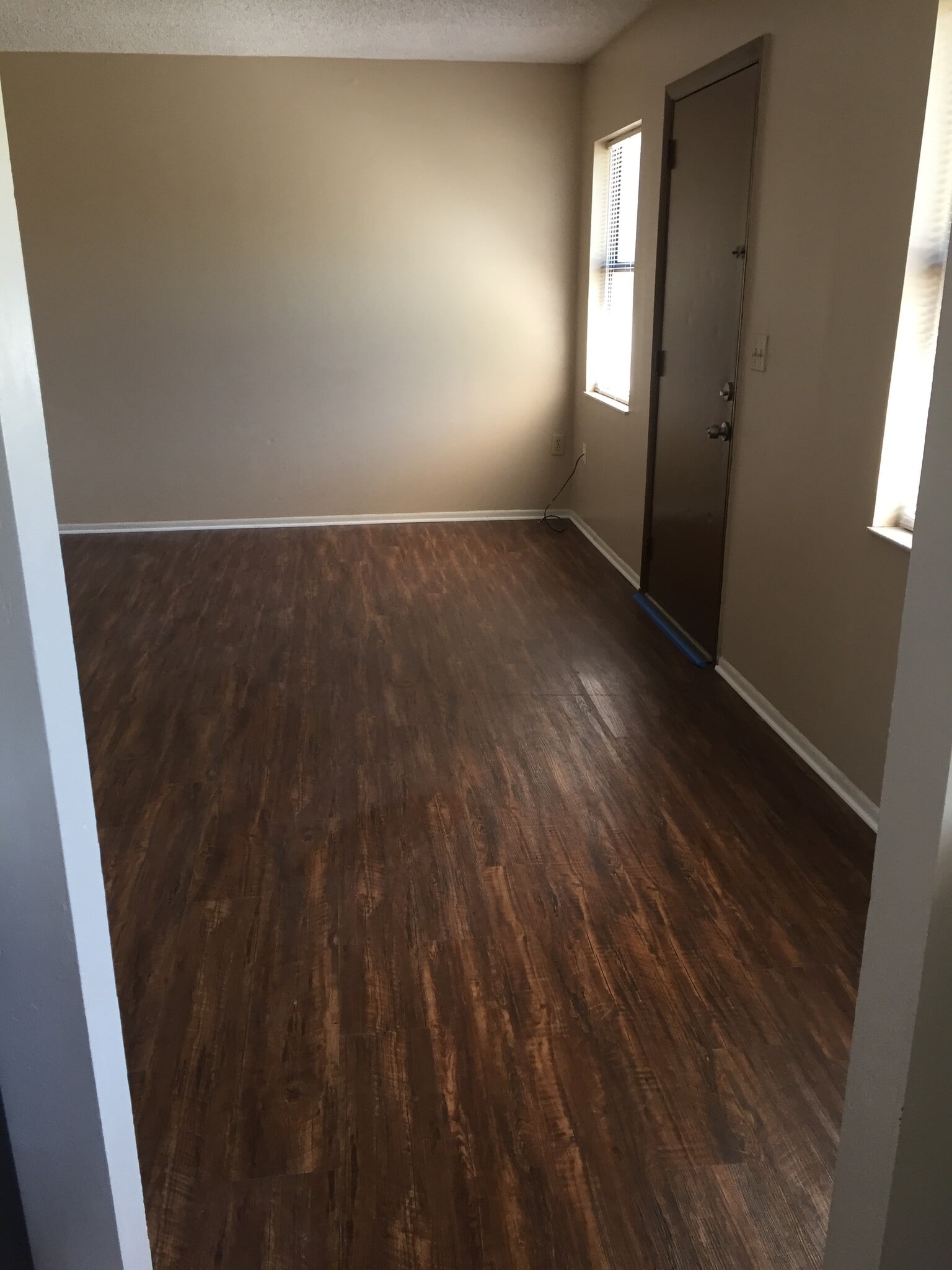 Living room. Freshly painted with vinyl plank flooring. - 2418 S San Gully Rd