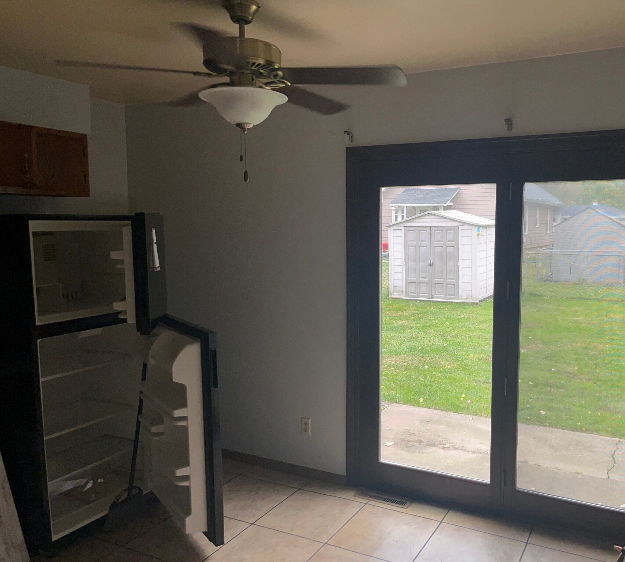 French door to fenced backyard and storage shed. - 721 West St