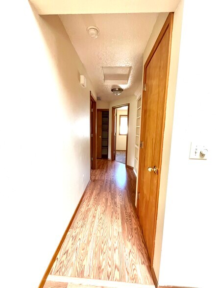 Hallway with coat closet, built in bookshelf and hallway closet - 15354 SW Clifford Ct