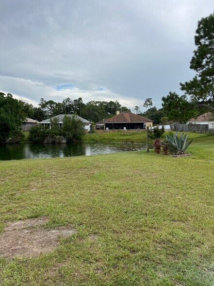 Water view from the living room and back patio — ideal for peaceful relaxation. - 5374 Lacy Jane Way
