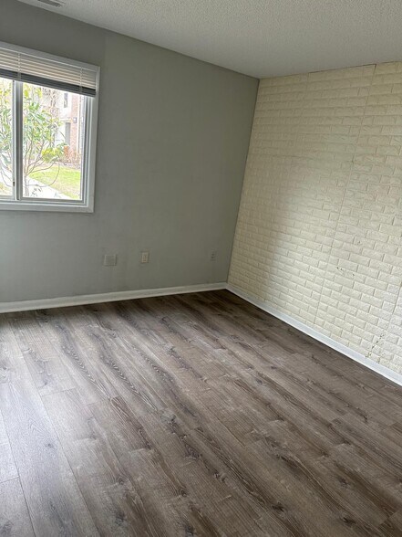 Master bedroom w/ custom white brick wallpaper (can be removed) - 505 Ravens Crest Dr