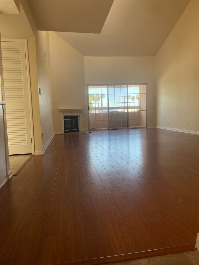 Large, bright dining and family room with vaulted ceilings, fireplace and private balcony. - 435 E Valencia Ave