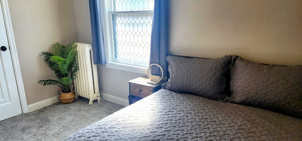 Wake up with the sunlight streaming through vintage leaded glass – soft, ambient light - 822 E 4th St