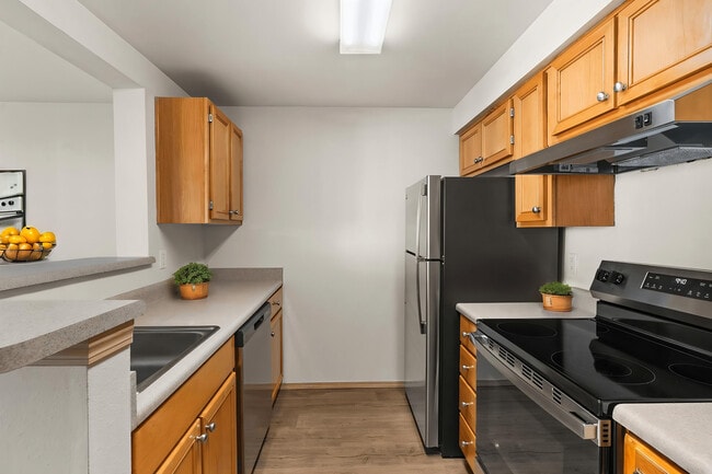 A welcoming kitchen with modern appliances and plenty of space to cook and gather. - Villas at Lawrence
