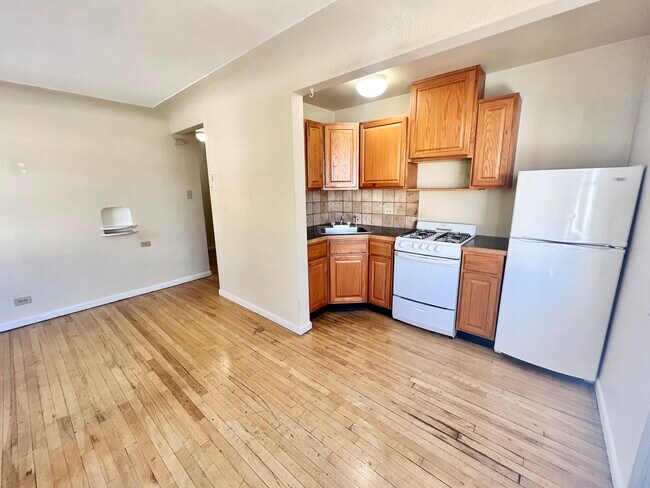 Experience the charm of this cozy kitchen and open living area, perfect for modern living. - Hillside Apartments
