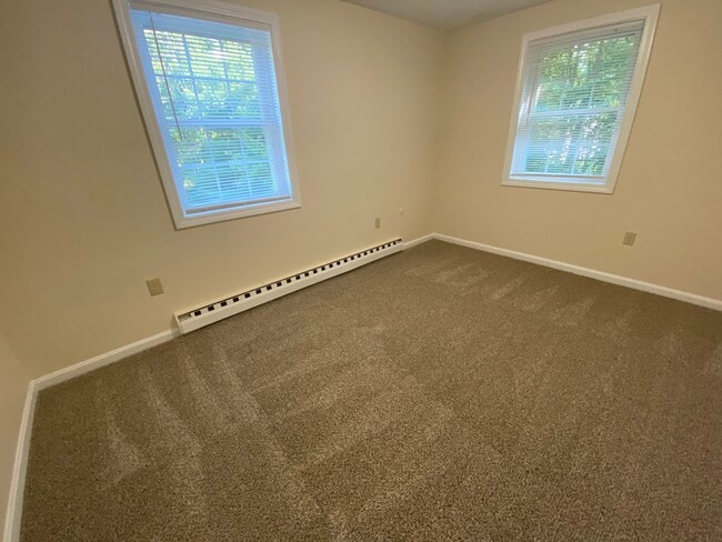 Carpeted Bedroom - Homestead Apartments