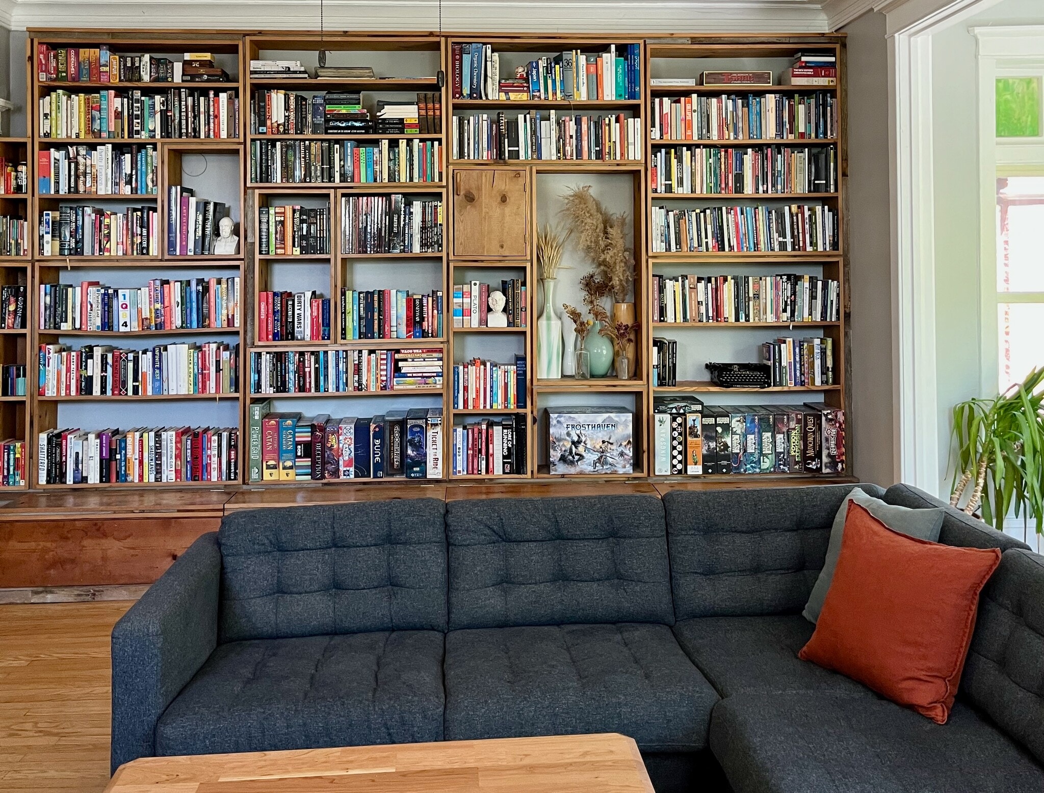 The living room also has built-in bookshelves made from reclaimed wood, with storage space below. - 5142 S Greenwood Ave