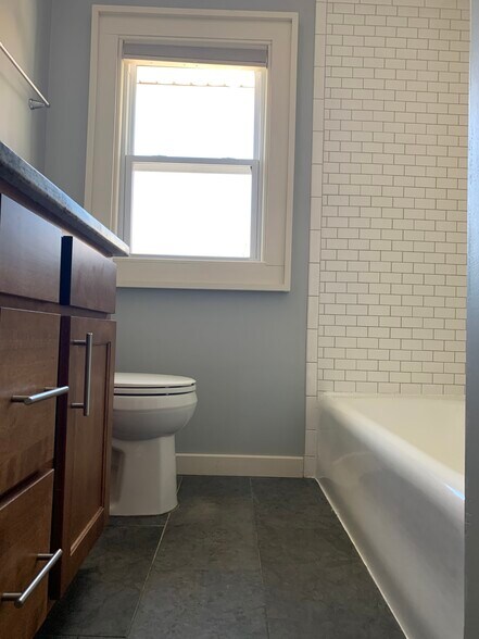 bath features subway tile, tub and showere combo - 4232 Urbandale Ave