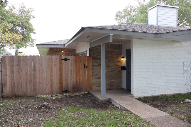 New fence, gate and inviting front porch to lounge on. - 13559 Red Fern Ln