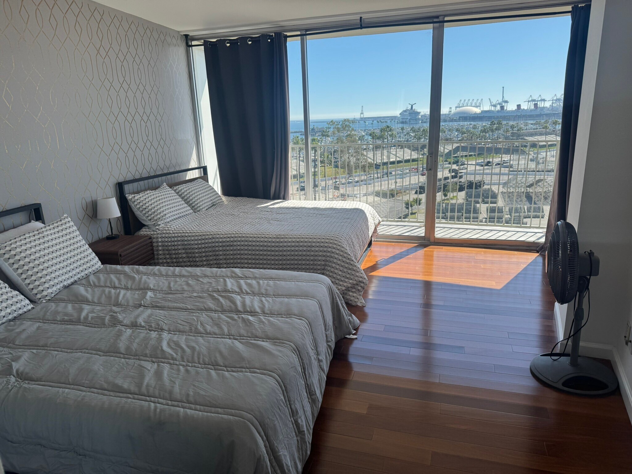 Bedroom featuring magnificiant view, floor to ceiling windows, wood floors, curtain and 2 queen beds - 700 E Ocean Blvd