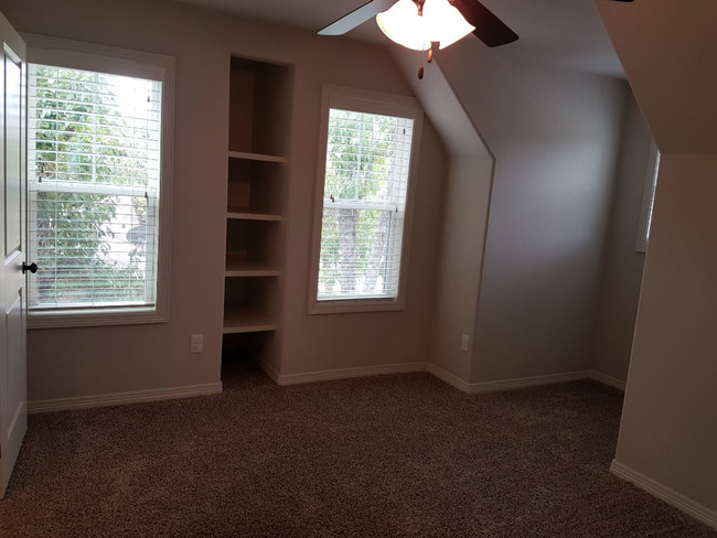 Bedroom including built-in book shelves and nook for study desk. - 113 Ehlinger Dr