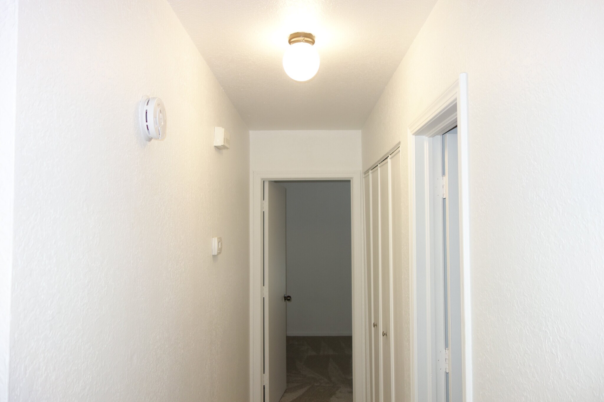 Hallway with Second and Third Bedrooms, Full Bath, and Laundry Room - 6604 S Utica Pl