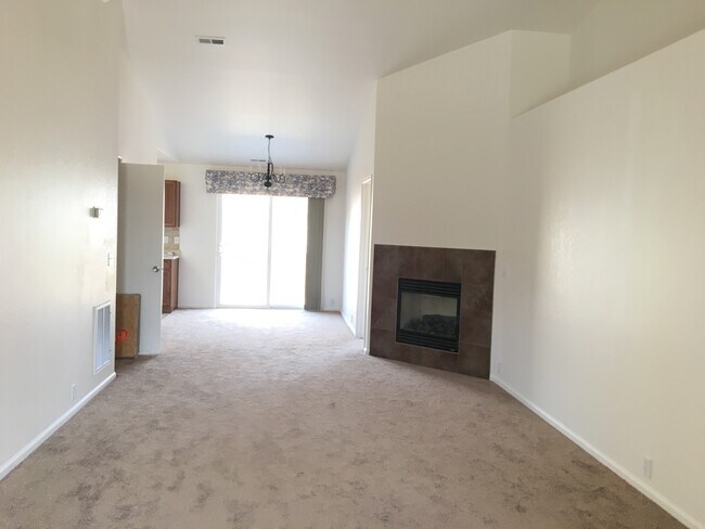 Living & Dining Room w/gas fireplace. Kitchen & Laundry off to side. - 6430 Sonny Blue Drive