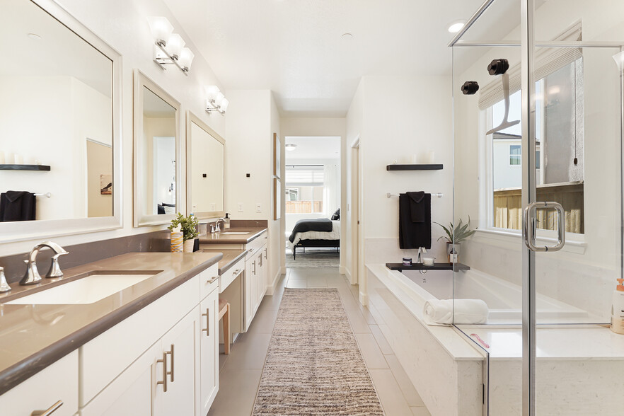 Master bath has double sinks, center make-up vanity, soaking tub separate from large walk-in shower. - 5919 Lakestone Dr