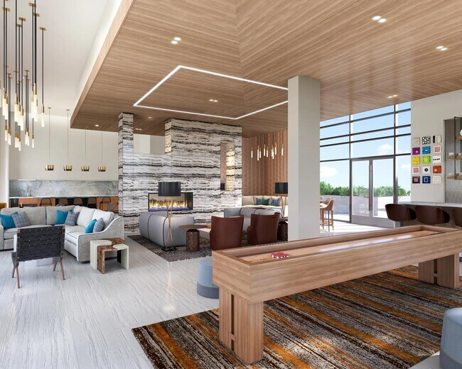 Game room with billiards, shuffleboard, bar area, fireplace, and lounge seating. - Modera McGavock