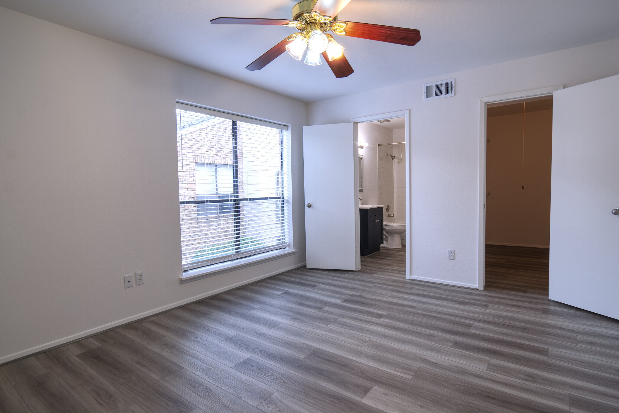 Primary Bedroom, seen from the southeast corner, featuring a window that faces West. - 2025 Augusta Dr