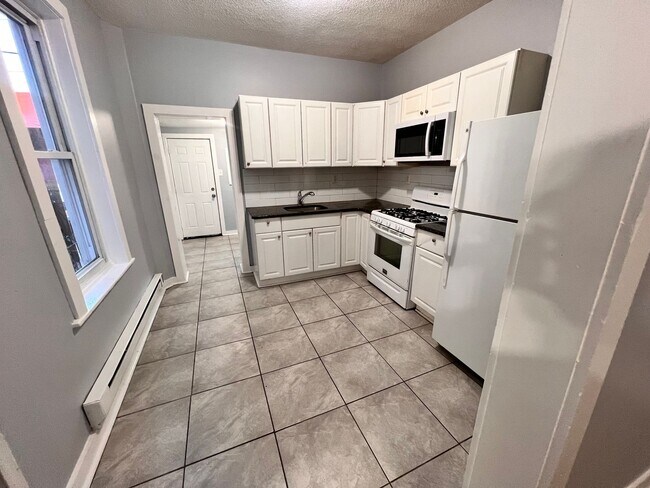 Building Photo - Updated 3 Bedroom 1.5 Bath Townhome w/ Paved Yard + Washer & Dryer