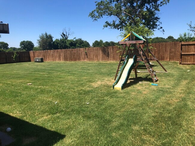 Backyard - fenced in from patio view - 337 N Sabine Pass Rd