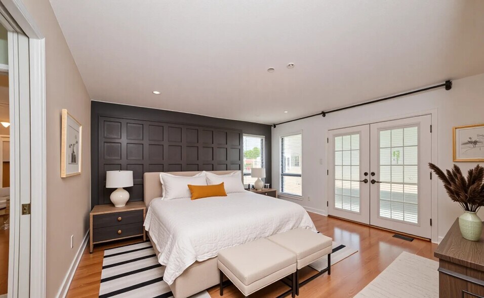 Spacious primary suite with French doors to the deck (virtually staged). - 6812 Uppingham Rd