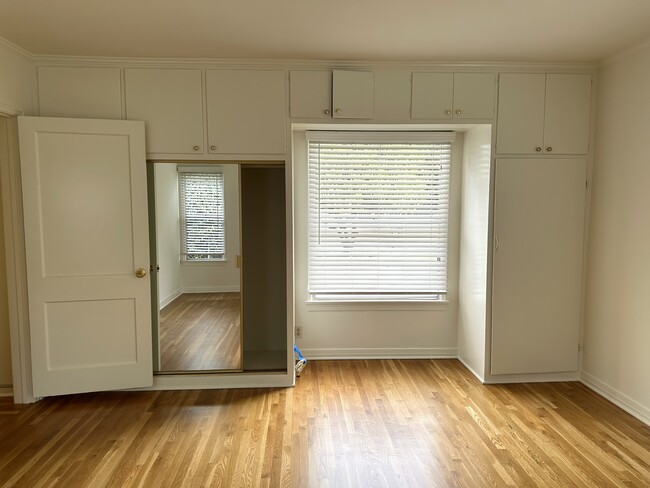 Light-filled bedroom with plenty of storage. - 5182 Woodley Ave