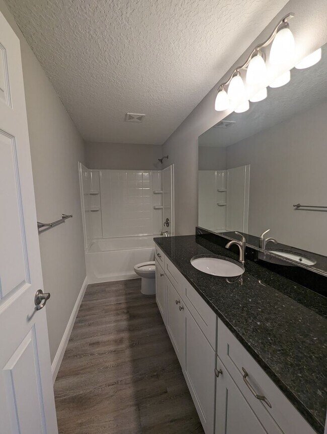 Building Photo - New 3/2/2 fenced home with Many Upgrades i...