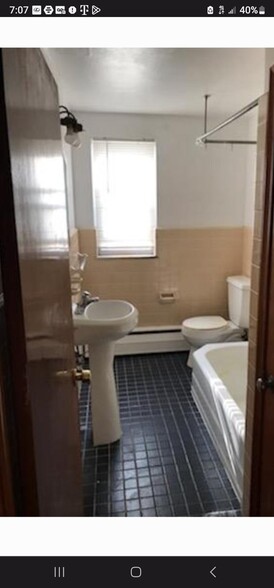 Full bathroom with a window - 100 E Park Ave